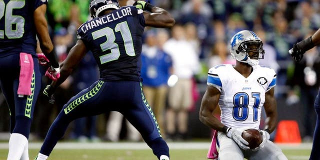 Oct 5, 2015; Seattle, WA, USA; Seattle Seahawks strong safety Kam Chancellor (31) reacts after his tackle against Detroit Lions wide receiver Calvin Johnson (81) during the fourth quarter at CenturyLink Field. Mandatory Credit: Joe Nicholson-USA TODAY Sports