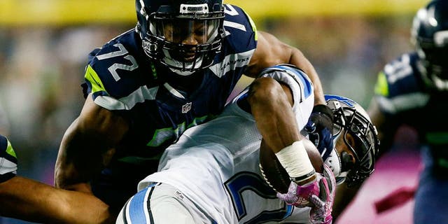 Oct 5, 2015; Seattle, WA, USA; Seattle Seahawks defensive end Michael Bennett (72) tackles Detroit Lions running back Ameer Abdullah (21) during the third quarter at CenturyLink Field. Mandatory Credit: Joe Nicholson-USA TODAY Sports
