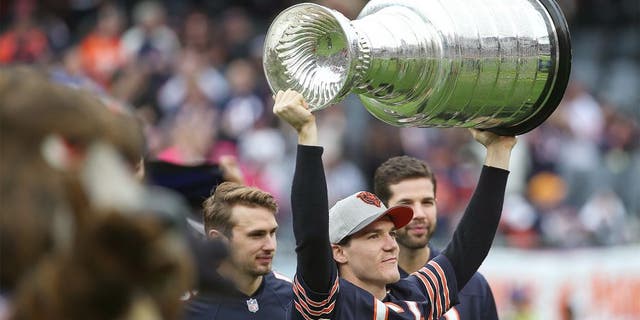 CHICAGO, IL - OCTOBER 04: Andrew Shaw #65 of the Chicago Blackhawks holds up the Stanley Cup prior to the NFL game between the Chicago Bears and the Oakland Raiders at Soldier Field on October 4, 2015 in Chicago, Illinois. The Chicago Bears defeated the Oakland Raiders 22-20. (Photo by Jonathan Daniel/Getty Images)