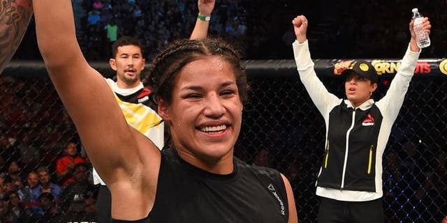 HOUSTON, TX - OCTOBER 03: Julianna Pena exchanges celebrates her victory over Jessica Eye in their women's bantamweight bout during the UFC 192 event at the Toyota Center on October 3, 2015 in Houston, Texas. (Photo by Josh Hedges/Zuffa LLC/Zuffa LLC via Getty Images)