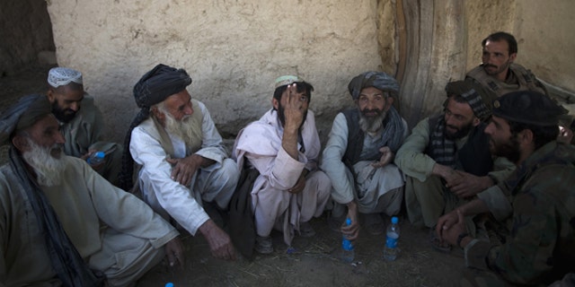 Oct. 6: Local residents meet with Afghan and U.S. soldiers to discuss security at an outpost near Forward Operation Base Howz-e-Madad, Zhari district, Kandahar province, Afghanistan.