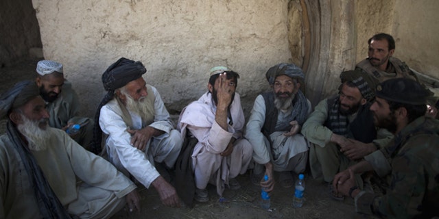 Oct. 6: Local residents meet with Afghan and U.S. soldiers to discuss security at an outpost near Forward Operation Base Howz-e-Madad, Zhari district, Kandahar province, Afghanistan.