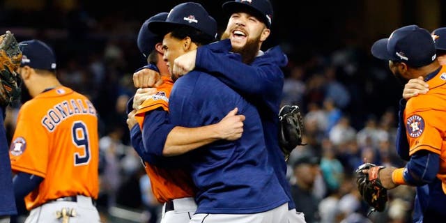 NEW YORK, NY - OCTOBER 06: The Houston Astros celebrate defeating the New York Yankees in the American League Wild Card Game at Yankee Stadium on October 6, 2015 in New York City. The Astros defeated the Yankees with a score of 3 to 0. (Photo by Al Bello/Getty Images)