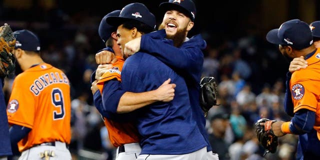NEW YORK, NY - OCTOBER 06: The Houston Astros celebrate defeating the New York Yankees in the American League Wild Card Game at Yankee Stadium on October 6, 2015 in New York City. The Astros defeated the Yankees with a score of 3 to 0. (Photo by Al Bello/Getty Images)