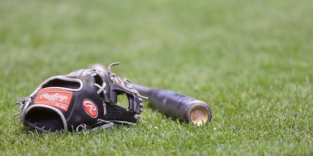 MILWAUKEE, WI - APRIL 25: A St. Louis Cardinals Rawling glove and bat on the grass before the game against the Milwaukee Brewers at Miller Park on April 25, 2015 in Milwaukee, Wisconsin. (Photo by Mike McGinnis/Getty Images)