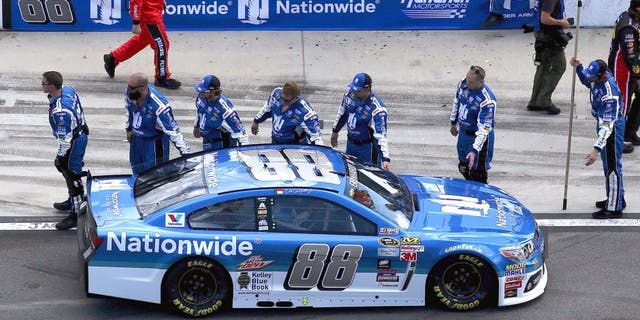 Dale Earnhardt Jr., driver of the #88 Nationwide Chevrolet, high-fives his crew on pit lane prior to the NASCAR Sprint Cup Series 57th Annual Daytona 500 at Daytona International Speedway on February 22, 2015 in Daytona Beach, Florida. (Photo by Sean Gardner/Getty Images)