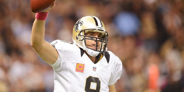 NEW ORLEANS, LA - OCTOBER 07: Quarterback Drew Brees #9 of the New Orleans Saints celebrates after his record breaking first quarter touchdown pass against the San Diego Chargers at Mercedes-Benz Superdome on October 7, 2012 in New Orleans, Louisiana. Brees has thrown a minimum of one touchdown pass in 48 straight regular season games. (Photo by Harry How/Getty Images)