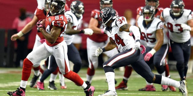 Oct 4, 2015; Atlanta, GA, USA; Atlanta Falcons wide receiver Roddy White (84) runs against Houston Texans cornerback A.J. Bouye (34) during the first half at the Georgia Dome. The Falcons defeated the Texans 48-21. Mandatory Credit: Dale Zanine-USA TODAY Sports