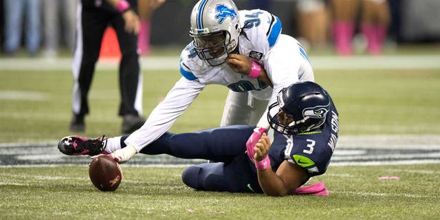 Oct 5, 2015; Seattle, WA, USA; Detroit Lions defensive end Ezekiel Ansah (94) recovers a fumble after sacking Seattle Seahawks quarterback Russell Wilson (3) during the fourth quarter at CenturyLink Field. The Seahawks won 13-10. Mandatory Credit: Troy Wayrynen-USA TODAY Sports