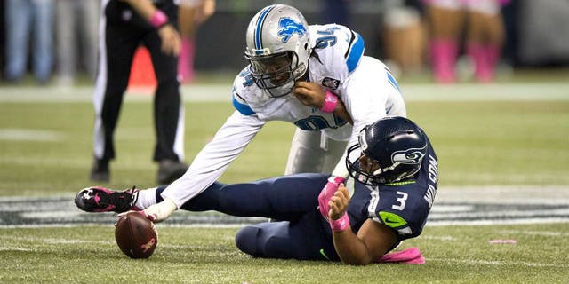 Oct 5, 2015; Seattle, WA, USA; Detroit Lions defensive end Ezekiel Ansah (94) recovers a fumble after sacking Seattle Seahawks quarterback Russell Wilson (3) during the fourth quarter at CenturyLink Field. The Seahawks won 13-10. Mandatory Credit: Troy Wayrynen-USA TODAY Sports