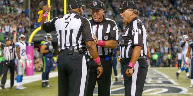 SEATTLE, WA - OCTOBER 05: Referees confer after the ball was batted out of the end zone by outside linebacker K.J. Wright of the Seattle Seahawks following a fumble by wide receiver Calvin Johnson of the Detroit Lions in the fourth quarter at CenturyLink Field on October 5, 2015 in Seattle, Washington. The Seahawks defeated the Lions 13-10. (Photo by Otto Greule Jr/Getty Images)