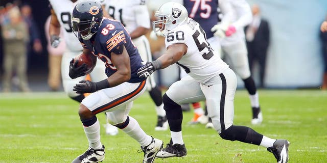 Oct 4, 2015; Chicago, IL, USA; Chicago Bears tight end Martellus Bennett (83) is tackled by Oakland Raiders middle linebacker Curtis Lofton (50) during the first quarter at Soldier Field. Mandatory Credit: Jerry Lai-USA TODAY Sports