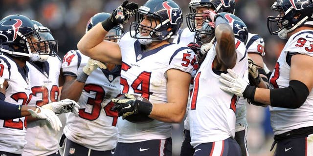 Nov 16, 2014; Cleveland, OH, USA; Houston Texans inside linebacker Mike Mohamed (54) and the Texans defense celebrates his fourth quarter interception against the Cleveland Browns at FirstEnergy Stadium. The Texans beat the Browns 23-7. Mandatory Credit: Ken Blaze-USA TODAY Sports