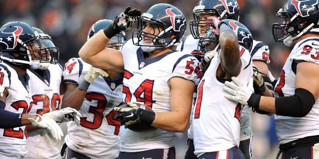 Nov 16, 2014; Cleveland, OH, USA; Houston Texans inside linebacker Mike Mohamed (54) and the Texans defense celebrates his fourth quarter interception against the Cleveland Browns at FirstEnergy Stadium. The Texans beat the Browns 23-7. Mandatory Credit: Ken Blaze-USA TODAY Sports