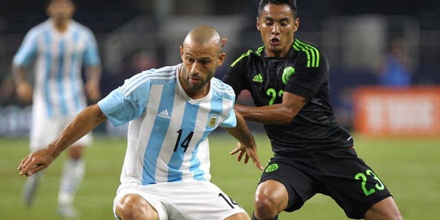 ARLINGTON, UNITED STATES - SEPTEMBER 08: Javier Mascherano of Argentina controls the ball as José Juan Vázquez defends during a friendly match between Argentina and Mexico at AT&T Stadium on September 08, 2015 in Arlington, United States. (Photo by Omar Vega/LatinContent/Getty Images)