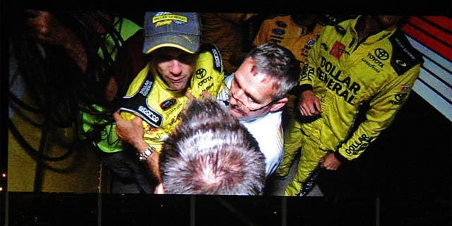 NASCAR Sprint Cup Series driver Matt Kenseth is involved in fisticuffs between haulers following the the Bank of America 500 in an image shown on the video display board at Charlotte Motor Speedway in Concord, N.C., on Saturday, Oct. 11, 2014. (Jeff Siner/Charlotte Observer/MCT)