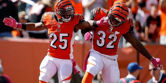 CINCINNATI, OH - OCTOBER 4: Giovani Bernard #25 of the Cincinnati Bengals is congratulated by Jeremy Hill #32 of the Cincinnati Bengals after scoring a touchdown during the first quarter of the game against the Kansas City Chiefs at Paul Brown Stadium on October 4, 2015 in Cincinnati, Ohio. (Photo by Joe Robbins/Getty Images)