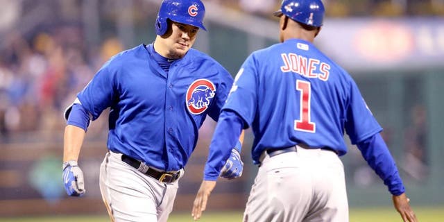 Oct 7, 2015; Pittsburgh, PA, USA; Chicago Cubs right fielder Kyle Schwarber (12) high fives third base coach Gary Jones (1) after hitting a two-run home run against the Pittsburgh Pirates during the third inning in the National League Wild Card playoff baseball game at PNC Park. Mandatory Credit: Charles LeClaire-USA TODAY Sports