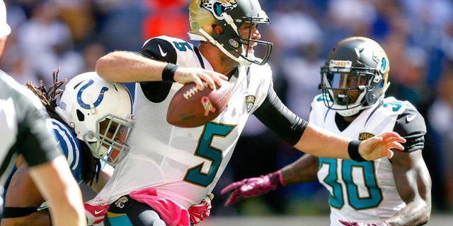 INDIANAPOLIS, IN - OCTOBER 4: Blake Bortles #5 of the Jacksonville Jaguars looks downfield to pass as Clayton Geathers #42 of the Indianapolis Colts tries to make the sack from behind at Lucas Oil Stadium on October 4, 2015 in Indianapolis, Indiana. Indianapolis defeated Jacksonville 16-13. (Photo by Michael Hickey/Getty Images)