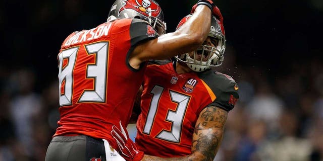 NEW ORLEANS, LA - SEPTEMBER 20: Mike Evans #13 celebrates with Vincent Jackson #83 of the Tampa Bay Buccaneers following his touchdown reception during the second quarter of a game against the New Orleans Saints at the Mercedes-Benz Superdome on September 20, 2015 in New Orleans, Louisiana. (Photo by Wesley Hitt/Getty Images)