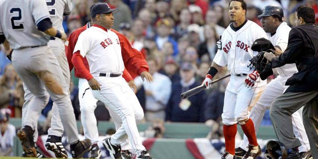 BOSTON - OCTOBER 11: Manny Ramirez #24 of the Boston Red Sox reacts after a pitch by Roger Clemens #22 of the New York Yankees during the fourth inning of Game 3 of the 2003 American League Championship Series on October 11, 2003 at Fenway Park in Boston, Massachusettes. (Photo by Jed Jacobsohn/Getty Images)