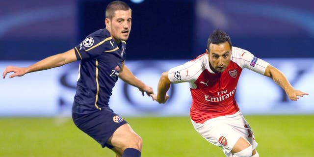 ZAGREB, CROATIA - SEPTEMBER 16: Santi Cazorla of Arsenal goes past Arijan Ademi of Dinamo Zagreb during the UEFA Champions League Group F match between Dinamo Zagreb and Arsenal at Maksimir Stadium on September 16, 2015 in Zagreb, Croatia. (Photo by Alexander Hassenstein/Getty Images)