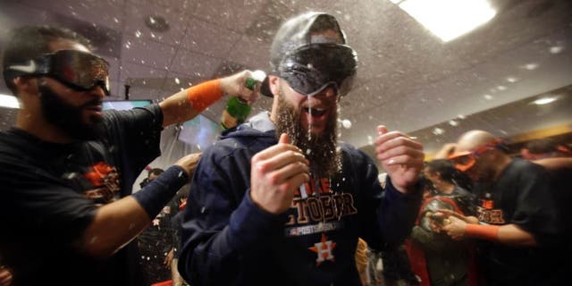 Oct 6, 2015; Bronx, NY, USA; Houston Astros starting pitcher Dallas Keuchel (right) celebrates with teammates in the locker room after defeating the New York Yankees in the American League Wild Card playoff baseball game at Yankee Stadium. Houston won 3-0. Mandatory Credit: Adam Hunger-USA TODAY Sports
