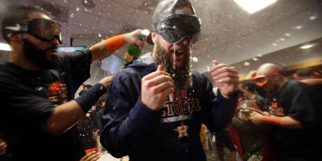 Oct 6, 2015; Bronx, NY, USA; Houston Astros starting pitcher Dallas Keuchel (right) celebrates with teammates in the locker room after defeating the New York Yankees in the American League Wild Card playoff baseball game at Yankee Stadium. Houston won 3-0. Mandatory Credit: Adam Hunger-USA TODAY Sports