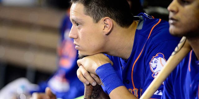 Aug 22, 2015; Denver, CO, USA; New York Mets shortstop Wilmer Flores (4) in his dugout in the ninth inning against the Colorado Rockies at Coors Field. The Mets defeated the Rockies 14-9. Mandatory Credit: Ron Chenoy-USA TODAY Sports