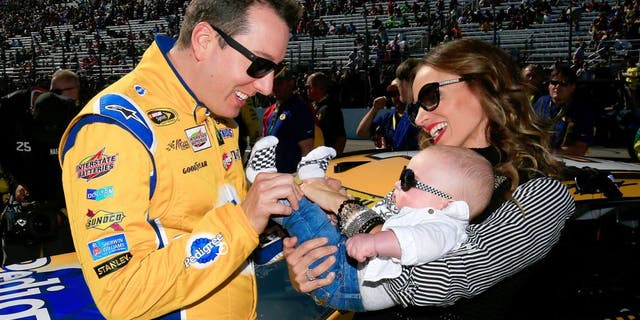 LOUDON, NH - SEPTEMBER 27: Kyle Busch, driver of the #18 Pedigree Toyota, stands on the grid with his wife, Samantha, and son, Brexton, prior to the NASCAR Sprint Cup Series SYLVANIA 300 at New Hampshire Motor Speedway on September 27, 2015 in Loudon, New Hampshire. (Photo by Chris Trotman/Getty Images)