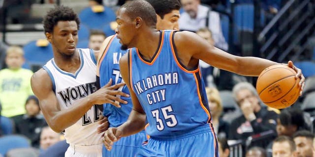 Oklahoma City Thunderâs Kevin Durant, right, drives as Enes Kanter sets a pick on Minnesota Timberwolvesâ Andrew Wiggins, left, in the first half of an NBA preseason basketball game Wednesday, Oct. 7, 2015, in Minneapolis. (AP Photo/Jim Mone)