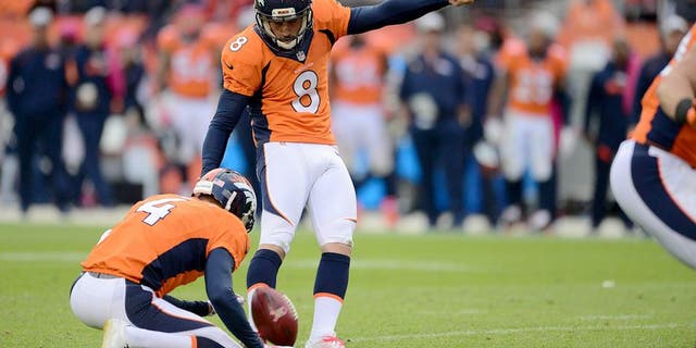 Oct 4, 2015; Denver, CO, USA; Denver Broncos kicker Brandon McManus (8) kicks the go ahead field goal as punter Britton Colquitt (4) holds late in the fourth quarter against the Minnesota Vikings at Sports Authority Field at Mile High. The Broncos defeated the Vikings 23-20. Mandatory Credit: Ron Chenoy-USA TODAY Sports