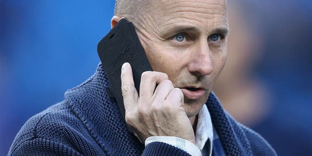TORONTO, CANADA - SEPTEMBER 21: General manager Brian Cashman of the New York Yankees talks on the phone during batting practice before the start of MLB game action against the Toronto Blue Jays on September 21, 2015 at Rogers Centre in Toronto, Ontario, Canada. (Photo by Tom Szczerbowski/Getty Images)