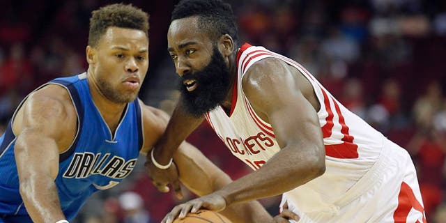 Oct 7, 2015; Houston, TX, USA; Houston Rockets guard James Harden (13) dribbles against Dallas Mavericks guard Justin Anderson (1) in the first quarter at Toyota Center. Mandatory Credit: Thomas B. Shea-USA TODAY Sports