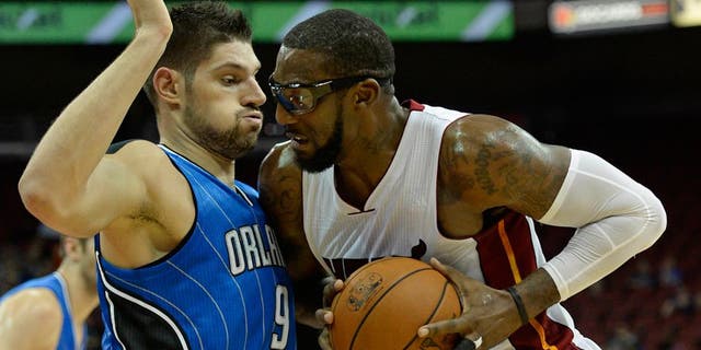 Oct 7, 2015; Louisville, KY, USA; Miami Heat forward Amar'e Stoudemire (5) posts up against Orlando Magic center Nikola Vucevic (9) during the second quarter at KFC Yum! Center. Mandatory Credit: Jamie Rhodes-USA TODAY Sports