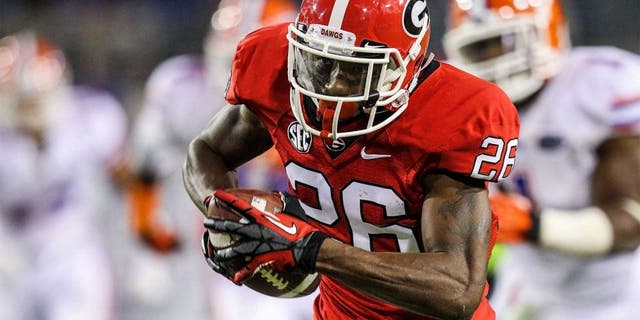 Oct 27, 2012; Jacksonville, FL, USA; Georgia Bulldogs cornerback Malcolm Mitchell (26) runs after a catch for a touchdown in the fourth quarter against the Florida Gators at EverBank Field. The Bulldogs won 17-9. Mandatory Credit: Daniel Shirey-USA TODAY Sports
