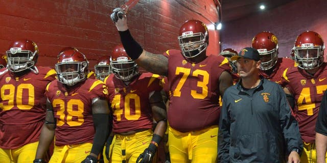 Oct 8, 2015; Los Angeles, CA, USA; Southern California Trojans coach Steve Sarkisian accompanies players onto the field before the game against the Washington Huskies at Los Angeles Memorial Coliseum. Mandatory Credit: Kirby Lee-USA TODAY Sports