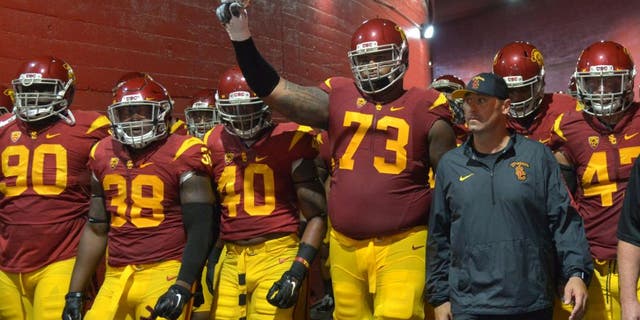 Oct 8, 2015; Los Angeles, CA, USA; Southern California Trojans coach Steve Sarkisian accompanies players onto the field before the game against the Washington Huskies at Los Angeles Memorial Coliseum. Mandatory Credit: Kirby Lee-USA TODAY Sports