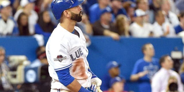 Oct 8, 2015; Toronto, Ontario, CAN; Toronto Blue Jays right fielder Jose Bautista hits a solo home run against the Texas Rangers in the sixth inning in game one of the ALDS at Rogers Centre. Mandatory Credit: Nick Turchiaro-USA TODAY Sports
