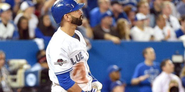 Oct 8, 2015; Toronto, Ontario, CAN; Toronto Blue Jays right fielder Jose Bautista hits a solo home run against the Texas Rangers in the sixth inning in game one of the ALDS at Rogers Centre. Mandatory Credit: Nick Turchiaro-USA TODAY Sports