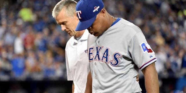 Oct 8, 2015; Toronto, Ontario, CAN; Texas Rangers third baseman Adrian Beltre is helped off the field in the third inning after an injury sustained against the Toronto Blue Jays in game one of the ALDS at Rogers Centre. Mandatory Credit: Nick Turchiaro-USA TODAY Sports