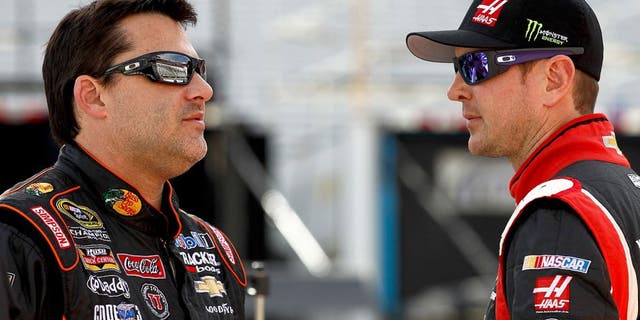 BRISTOL, TN - MARCH 14: Tony Stewart, driver of the #14 Bass Pro Shops / Mobil 1 Chevrolet, talks with Kurt Busch, driver of the #41 Haas Automation Chevrolet, on the grid during qualifying for the NASCAR Sprint Cup Series Food City 500 at Bristol Motor Speedway on March 14, 2014 in Bristol, Tennessee. (Photo by Jeff Zelevansky/NASCAR via Getty Images)