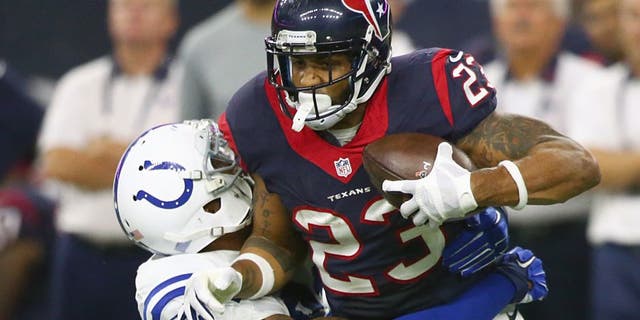 HOUSTON, TX - OCTOBER 08: Arian Foster #23 of the Houston Texans is tackled by Jonathan Newsome #91 of the Indianapolis Colts in the first quarter on October 8, 2015 at NRG Stadium in Houston, Texas. (Photo by Ronald Martinez/Getty Images)