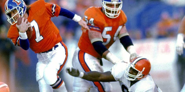 DENVER, CO - JANUARY 17: Quarterback John Elway #7 of the Denver Broncos runs upfield to elude the Cleveland Browns defense in the 1987 AFC Championship Game at Mile High Stadium on January 17, 1988 in Denver, Colorado. The Broncos defeated the Browns 38-33. (Photo by E.L. Bakke/Getty Images)