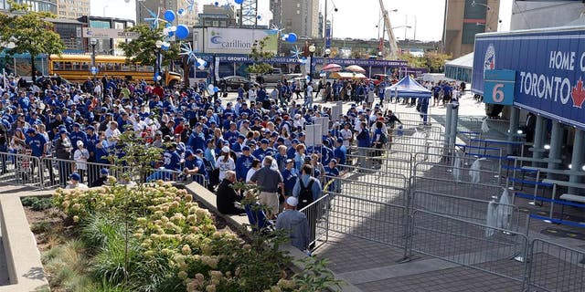 Oct 8, 2015; Toronto, Ontario, CAN; Fans of the Toronto Blue Jays line up outside the Rogers Centre prior to game one of the ALDS against the Texas Rangers. Mandatory Credit: Nick Turchiaro-USA TODAY Sports