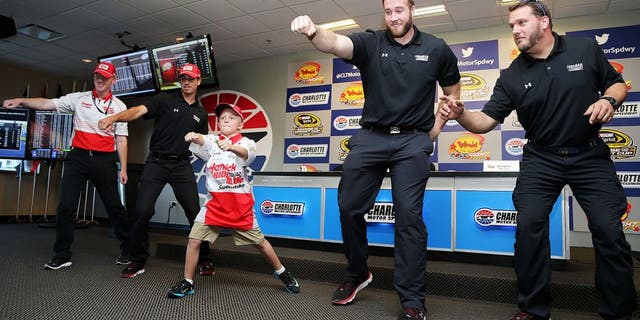CHARLOTTE, NC - OCTOBER 08: Crew chief for Kasey Kahne, driver of the #5 HendrickRideAlong.com Chevrolet, Keith Rodden (L), crew members and honorary crew chief Braylon Beam (C) dance during a press conference prior to qualifying for the NASCAR Sprint Cup Series Bank of America 500 at Charlotte Motor Speedway on October 8, 2015 in Charlotte, North Carolina. (Photo by Jerry Markland/Getty Images)