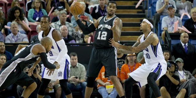 Oct 8, 2015; Sacramento, CA, USA; San Antonio Spurs forward LaMarcus Aldridge (12) dribbles the ball as Sacramento Kings center Willie Cauley-Stein (00) defends during the first quarter at Sleep Train Arena. Mandatory Credit: Kelley L Cox-USA TODAY Sports