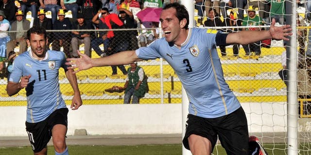 Uruguay's defender Diego Godin (R) celebrates after scoring against Bolivia during the Russia 2018 FIFA World Cup qualifiers match, at the Hernando Siles stadium in La Paz, on October 8, 2015. AFP PHOTO / AIZAR RALDES (Photo credit should read AIZAR RALDES/AFP/Getty Images)