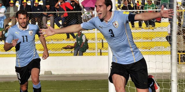 Uruguay's defender Diego Godin (R) celebrates after scoring against Bolivia during the Russia 2018 FIFA World Cup qualifiers match, at the Hernando Siles stadium in La Paz, on October 8, 2015. AFP PHOTO / AIZAR RALDES (Photo credit should read AIZAR RALDES/AFP/Getty Images)