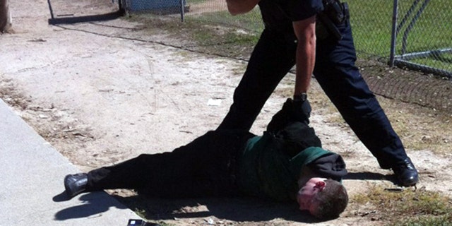 Oct 8: A bystander helps restrain Brendan L. O'Rourke, a suspect in shooting at a school in Carlsbad, Calif.